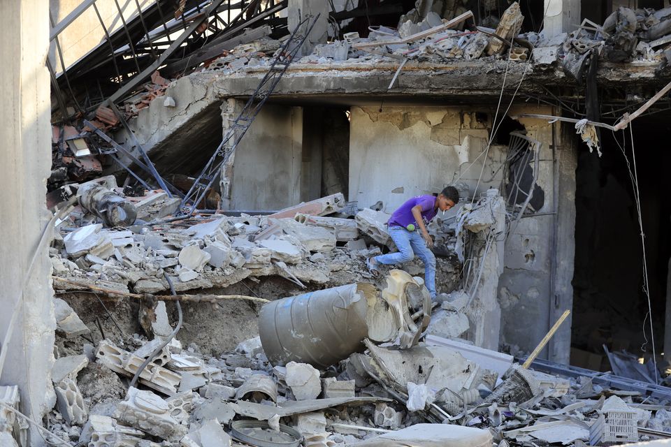 A boy checks the damage to a building hit in an Israeli airstrike in the southern village of Akbieh, Lebanon, on Tuesday (Mohammed Zaatari/AP)