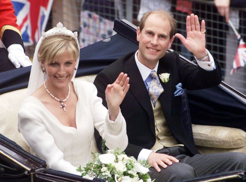 Smiling newlyweds Sophie and Edward, the new Earl and Countess of Wessex, wave to the crowds after their wedding at St George’s Chapel in 1999 (Sean Dempsey/PA)