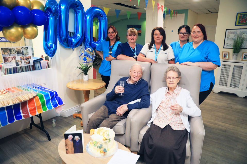 Elwyn Wilson celebrates his 100th birthday with wife Margaret and staff at Clifton House Residential home in north Belfast. Pic: Peter Morrison