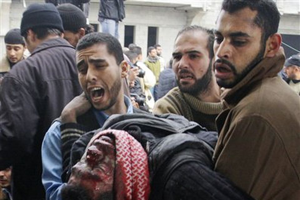 A Palestinian man wounded in an Israeli missile strike is carried into the emergency area at Shifa hospital in Gaza City, Saturday, Dec. 27, 2008. Israeli warplanes demolished dozens of Hamas security compounds across Gaza on Saturday in unprecedented waves of simultaneous air strikes. Gaza medics said more than 120 people were killed and more than 250 wounded.(AP Photo/Hatem Moussa)