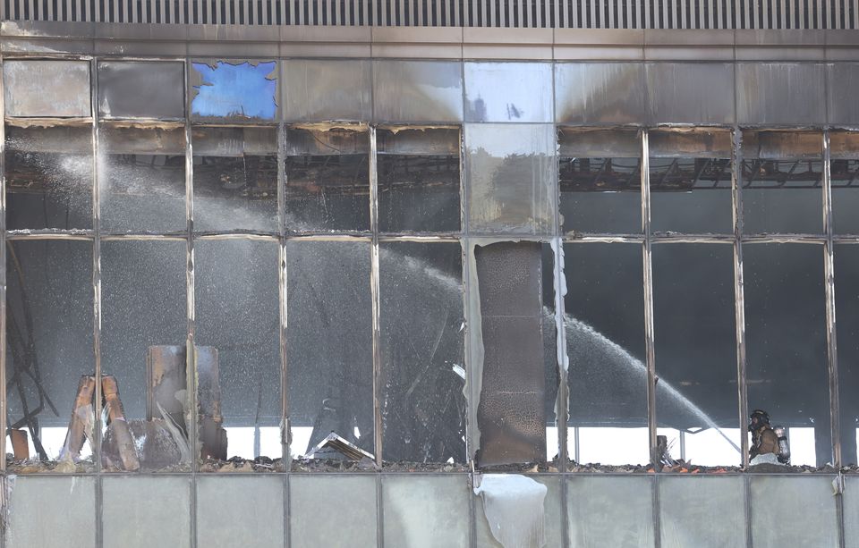 A firefighter works to extinguish a fire at a resort construction site in Busan (Gang Sun-bae/Yonhap via AP)