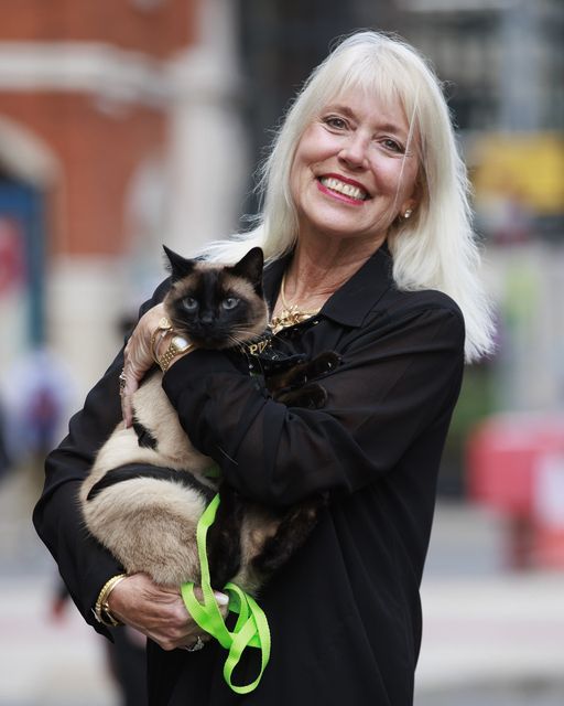 Holly Hennessy with her Siamese cat Captain at the Europa Hotel in Belfast (Liam McBurney/PA)