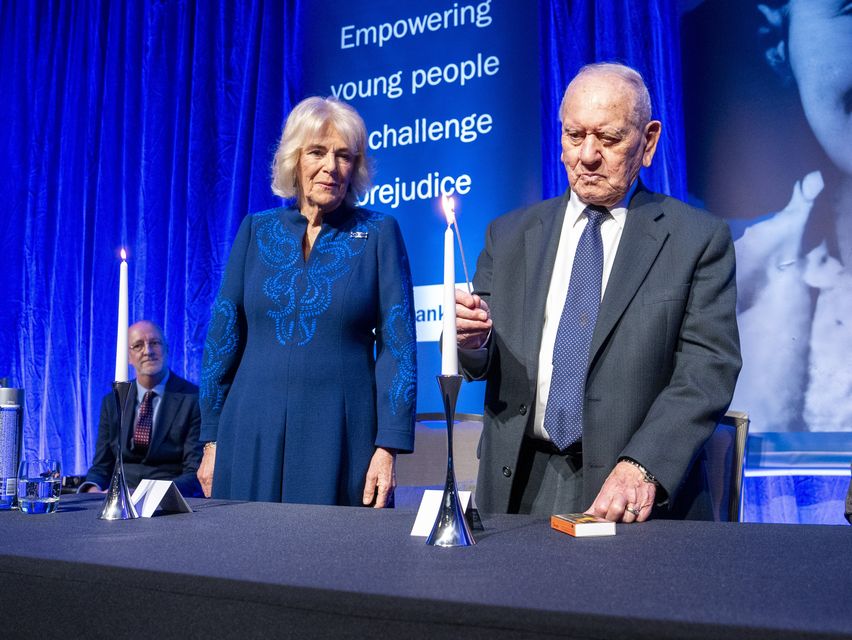 Queen Camilla watches Holocaust survivor Arem Hersch light a candle (Arthur Edwards/The Sun/PA)