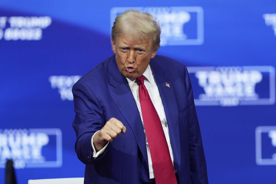 Former president Donald Trump gestures at a campaign town hall at the Greater Philadelphia Expo Centre & Fairgrounds (Matt Rourke/AP)