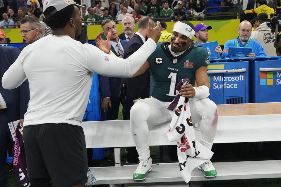 Philadelphia Eagles quarterback Jalen Hurts celebrates on the bench (Brynn Anderson/AP)