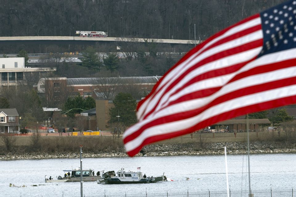 A diving team and police boat is seen around a wreckage site in the Potomac River (Jose Luis Magana/AP)