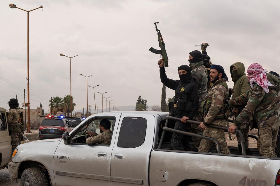 Members of the security forces of the newly formed Syrian government taking part in an operation to detain suspected militias of the ousted president Bashar Assad in Adra (Leo Correa/AP)