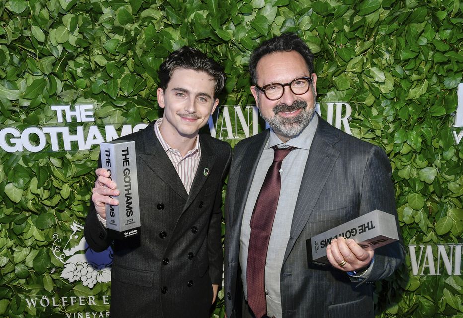 Timothee Chalamet, left, and James Mangold pose with the visionary tribute award for A Complete Unknown during The Gothams Film Awards (Evan Agostini/Invision/AP)