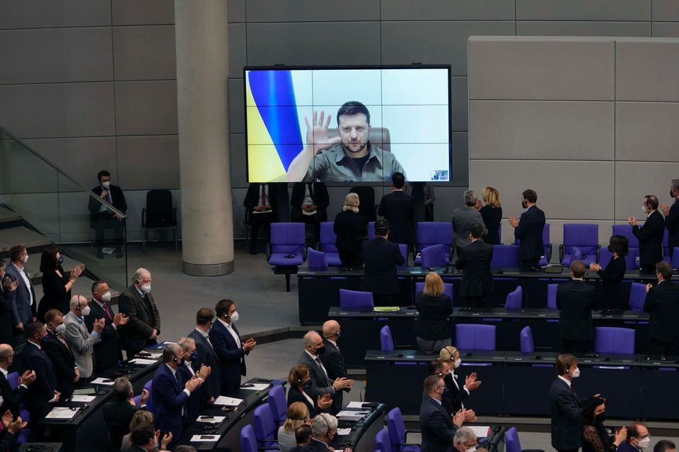 Members of the Bundestag give Volodymyr Zelensky a standing ovation after he speaks in a virtual address to the parliament at the Reichstag Building (Markus Schreiber/AP)