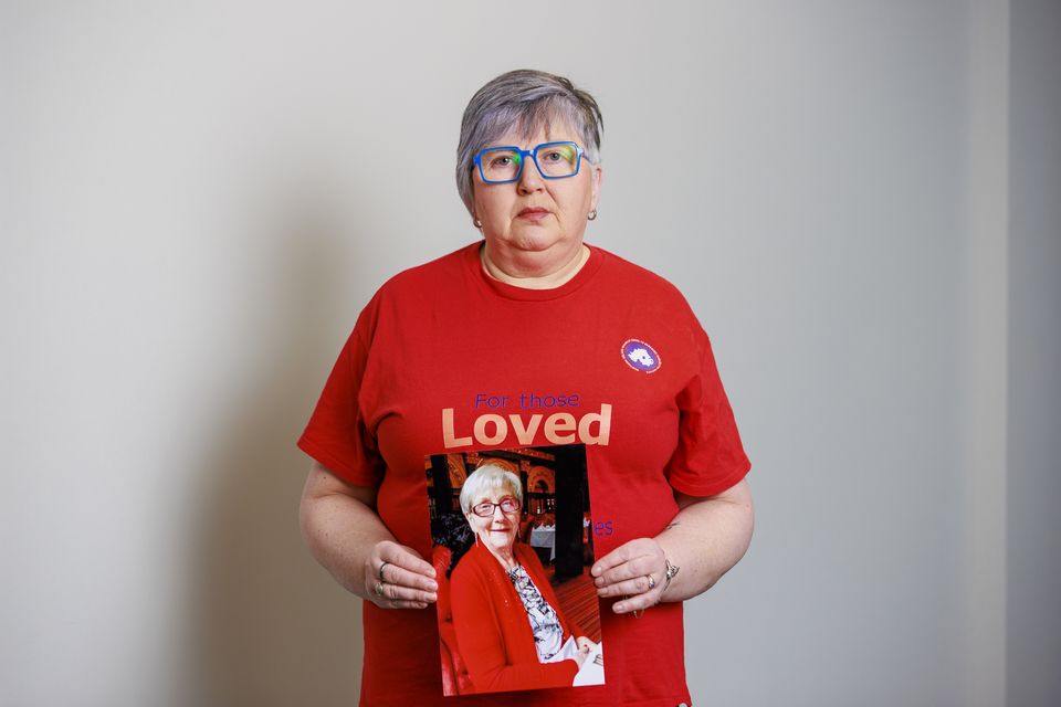 Brenda Doherty holds an image of her late mother Ruth Burke (Liam McBurney/PA)