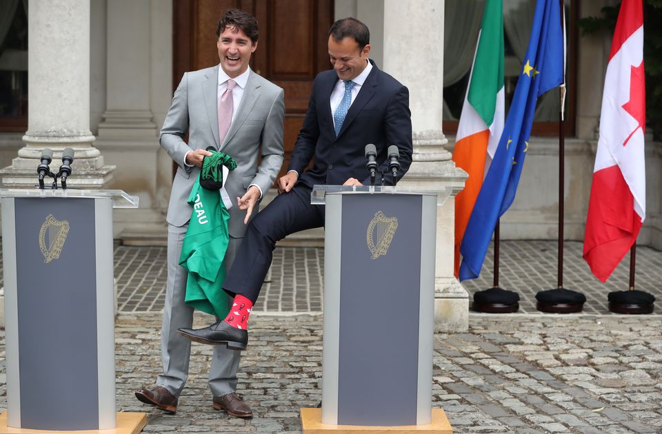 Leo Varadkar shows off his Canadian-themed socks during a press conference with Canadian Prime Minister Justin Trudeau (PA)