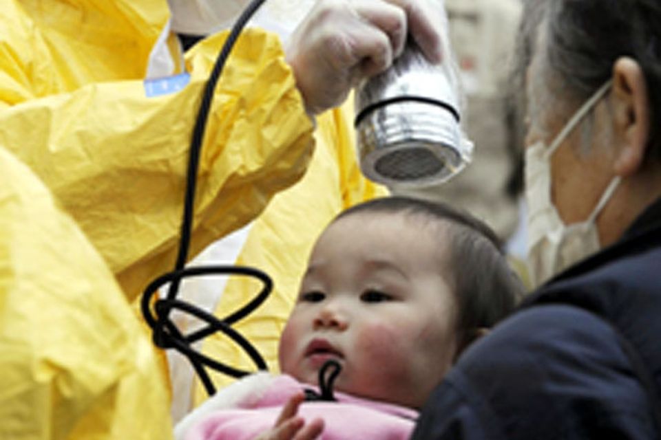 A baby is checked for radiation exposure level in Nihonmatsu in Fukushima prefecture (state) Tuesday, March 15, 2011 following a third explosion at the Fukushima Dai-ichi nuclear power complex Tuesday, March 15, 2011
