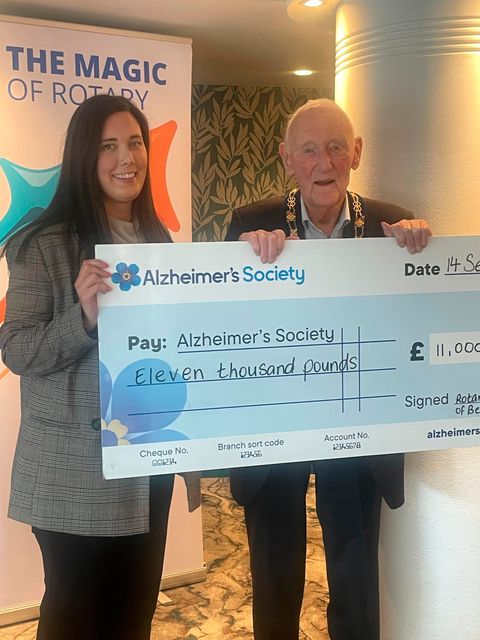 Billy presenting the cheque to Alzheimer's Society