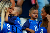 thumbnail: The beautiful game - football fans from around the world -  Ludivine Payet (1st L), wife of Dimitri Payet of France kisses her child prior to the match between Germany and France at Stade Velodrome on July 7, 2016 in Marseille, France.