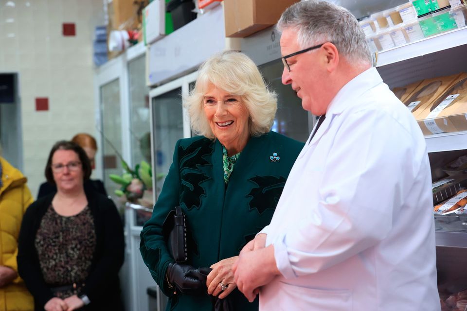 Queen Camilla meets the owner of Coffey's Butchers during a visit to Lisburn Road in Belfast to meet shop owners and staff. Image: Liam McBurney/PA Wire