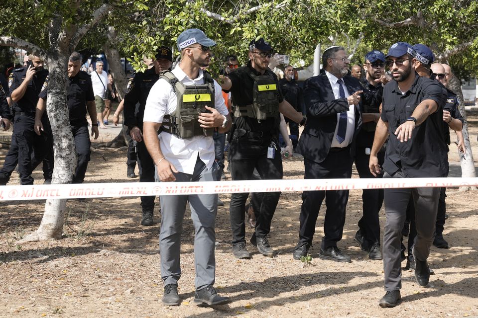 Israeli national security minister, Itamar Ben-Gvir, second from right, visiting the scene of the stabbing (Mahmoud Illean/AP)