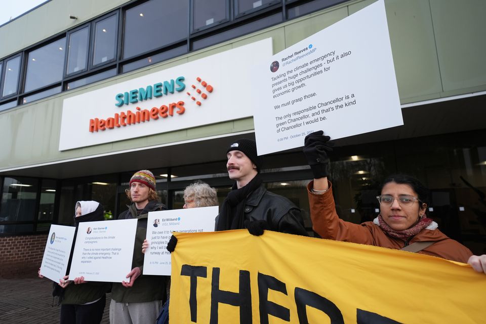 Activists from Fossil Free London and Green New Deal Rising protest against airport expansion plans outside Siemens Healthineers in Eynsham, Oxfordshire (Jacob King/PA)