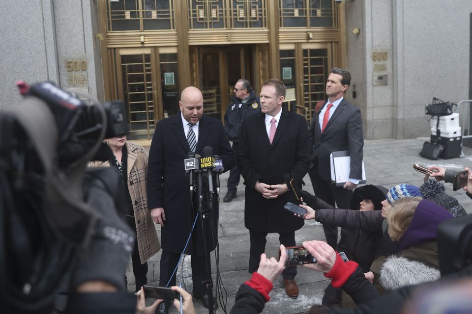 Giuliani’s lawyer, Joseph Cammarata, left, reads a statement alongside Giuliani’s son, Andrew, outside the court (Heather Khalifa/AP)