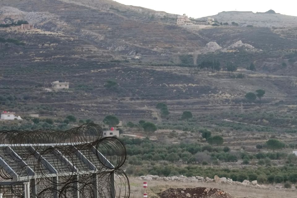 Israeli soldiers stand guard on a security fence gate near the so-called Alpha Line that separates the Israeli-occupied Golan Heights from Syria (Matias Delacroix/AP)