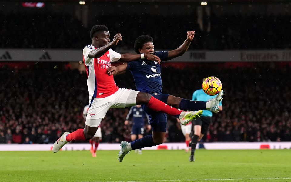 Tyrell Malacia (right) challenges Arsenal’s Bukayo Saka (John Walton/PA)