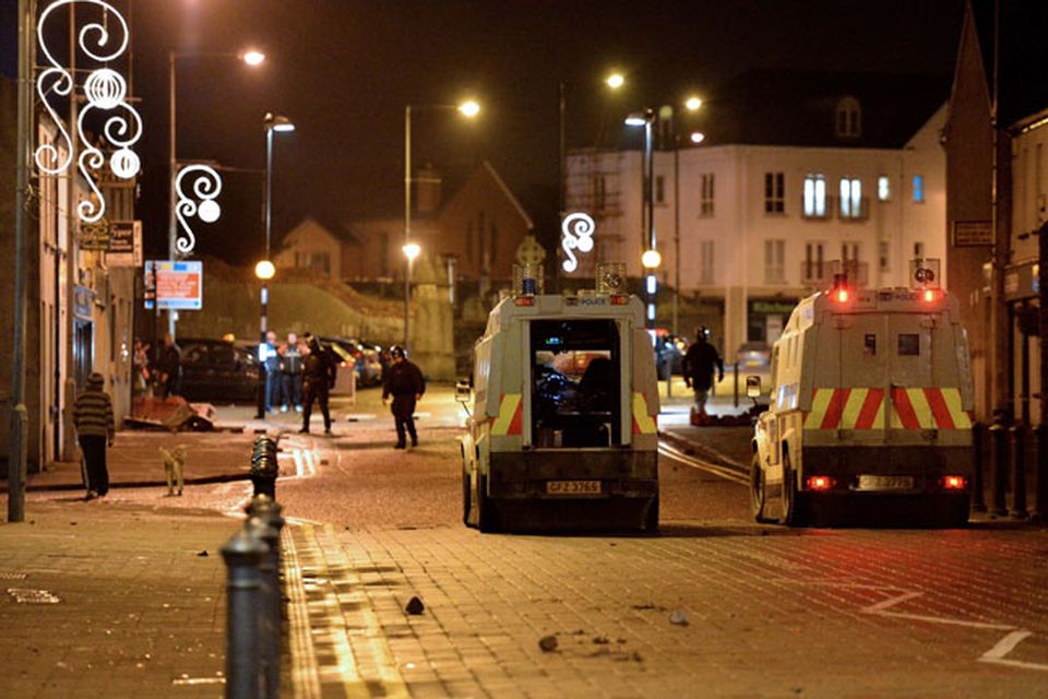 Police in Carrick come under attack from protestors following a fire at the  Alliance party office