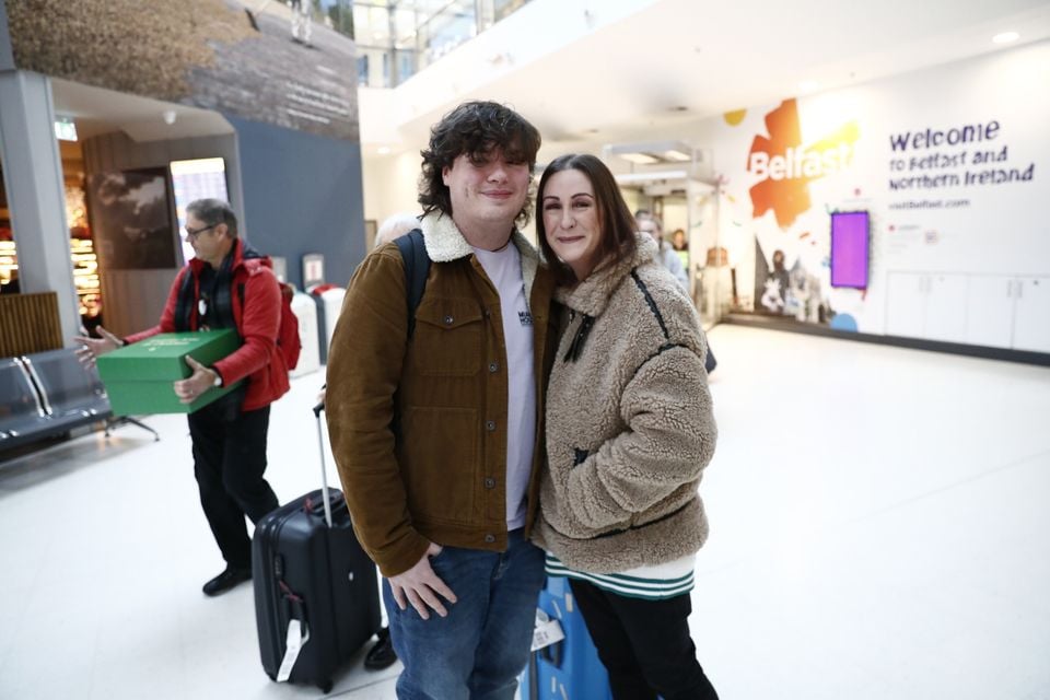 Emma Crawford greets her son Ben Crawford at Belfast City Airport as people arrive home for the Christmas holidays.  Picture by Peter Morrison