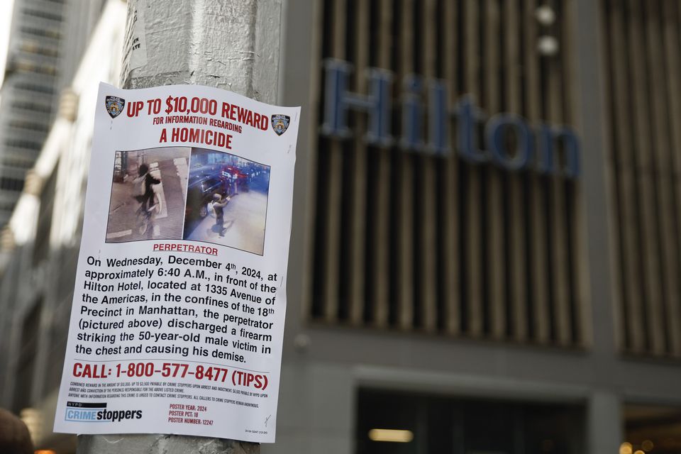 A reward poster hangs on a lamppost outside the Hilton Hotel (Stefan Jeremiah/AP)