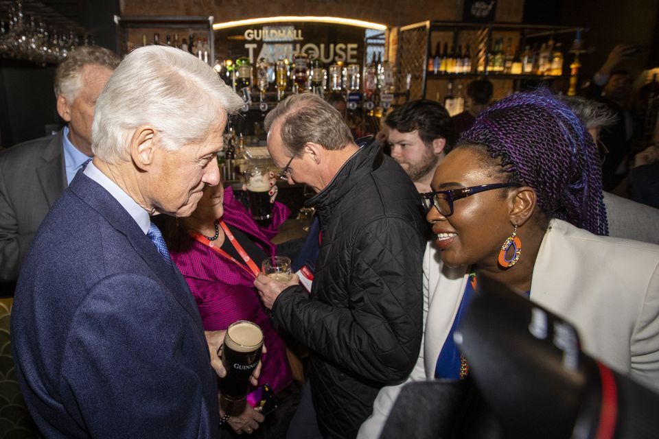 Former US President Bill Clinton speaking with Derry and Strabane District Councillor Lilian Seenoi-Barr in the Guildhall Taphouse (PA)
