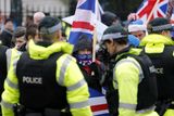 thumbnail: Loyalist protestors and PSNI officers pictured at Belfast City Hall on 22 December 2012