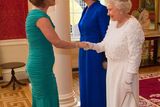 thumbnail: Queen Elizabeth II (R) greets Iris Robinson, the wife of Northern Ireland First Minister Peter Robinson with Irish President Mary McAleese (C) at the State Banquet in Dublin Castle on May 18, 2011 i