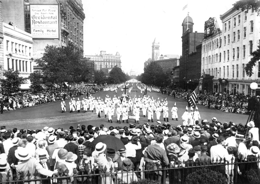 The Ku Klux Klan marches down Pennsylvania Avenue past the Treasury Building in Washington DC in 1925 (AP)