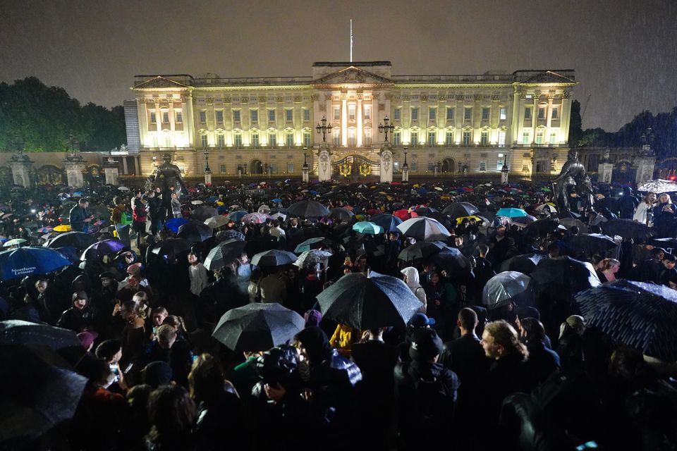 Members of the public gather outside Buckingham Palace on the day the Queen died (Victoria Jones/PA)