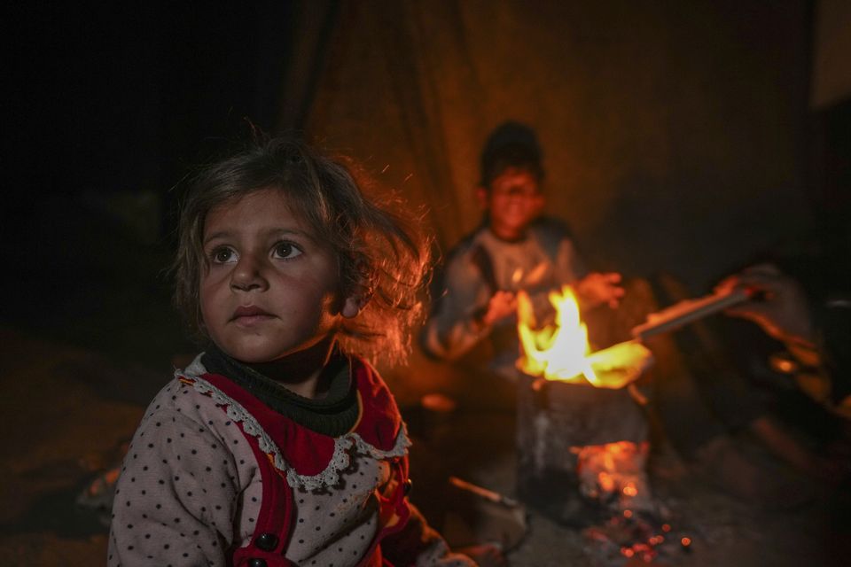 Many Palestinian children are enduring wintry weather in threadbare tents which lack basic supplies (Abdel Kareem Hana/AP)