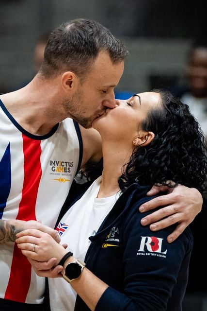 Army veteran James Cairns kisses his partner Hannah Wild after his ‘gold medal moment'(Aaron Chown/PA)