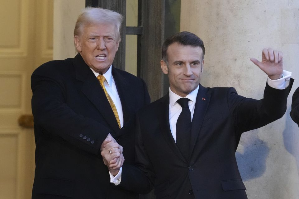 Emmanuel Macron, right, and Donald Trump shake hands outside the Elysee Palace (Michel Euler/AP)