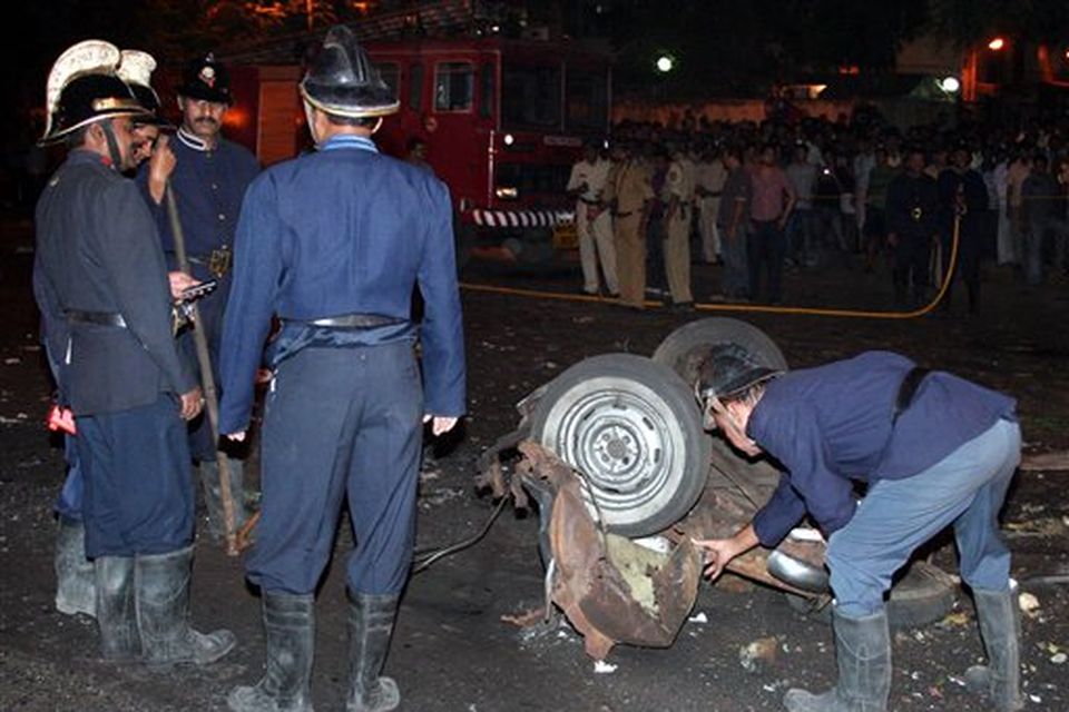 Firefighters inspect the site of an explosion in Mumbai, India, Wednesday, Nov. 26, 2008. Gunmen targeted luxury hotels, a popular tourist attraction and a crowded train station in at least seven attacks in India's financial capital Wednesday, wounding 25 people, police and witnesses said. A.N Roy police commissioner of Maharashtra state, of which Mumbai is the capital, said several people had been wounded in the attacks and police were battling the gunmen. "The terrorists have used automatic weapons and in some places grenades have been lobbed," said Roy. Gunmen opened fire on two of the city's best known Luxury hotels, the Taj Mahal and the Oberoi. They also attacked the crowded Chhatrapati Shivaji Terminus station in southern Mumbai and Leopold's restaurant, a Mumbai landmark. It was not immediately clear what the motive was for the attacks. (AP Photo)