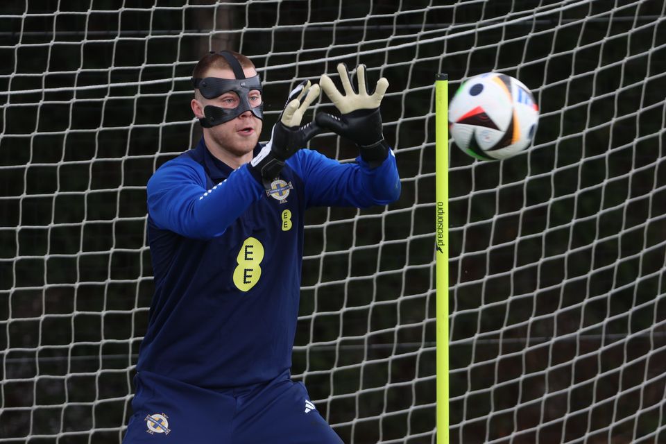 Northern Ireland keeper Bailey Peacock-Farrell dons his protective mask in preparation for the Romania friendly