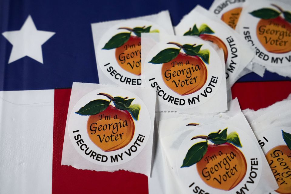 Stickers sit on a table inside a polling place in Atlanta (Brynn Anderson/AP)