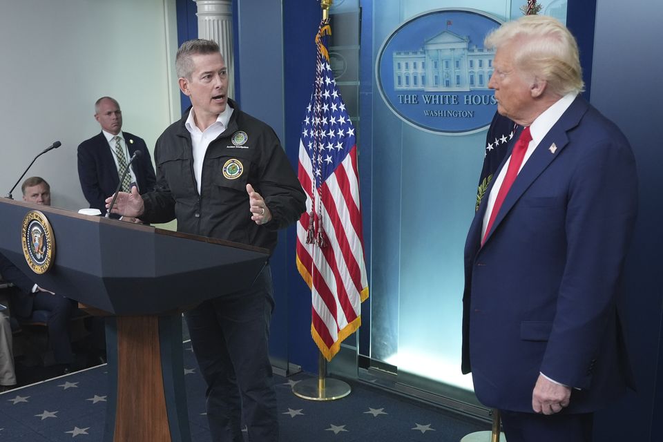 President Donald Trump stands beside Transportation Secretary Sean Duffy (Jacquelyn Martin/AP)