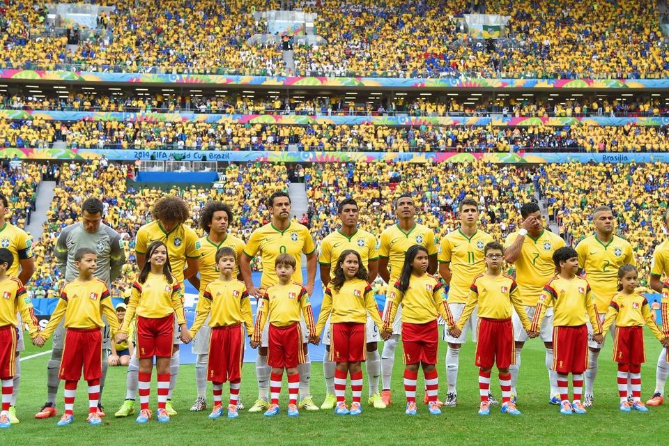 BRASILIA, BRAZIL - JUNE 23:  Brazil look on during the National Anthem prior to the 2014 FIFA World Cup Brazil Group A match between Cameroon and Brazil at Estadio Nacional on June 23, 2014 in Brasilia, Brazil.  (Photo by Buda Mendes/Getty Images)