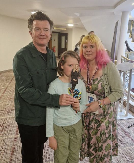 Rick Astley (left), with Helen Tamblyn-Saville (right) and her daughter (middle) and Chopstick Sally (Wonderland Bookshop/PA)