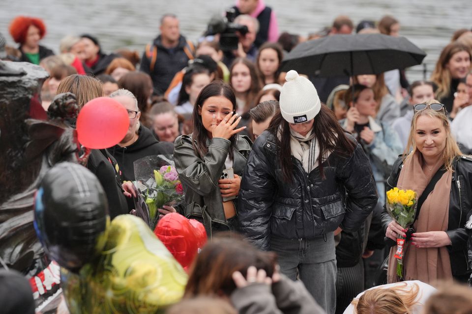 People attend a vigil for 31-year-old One Direction singer Liam Payne (Jonathan Brady/PA)