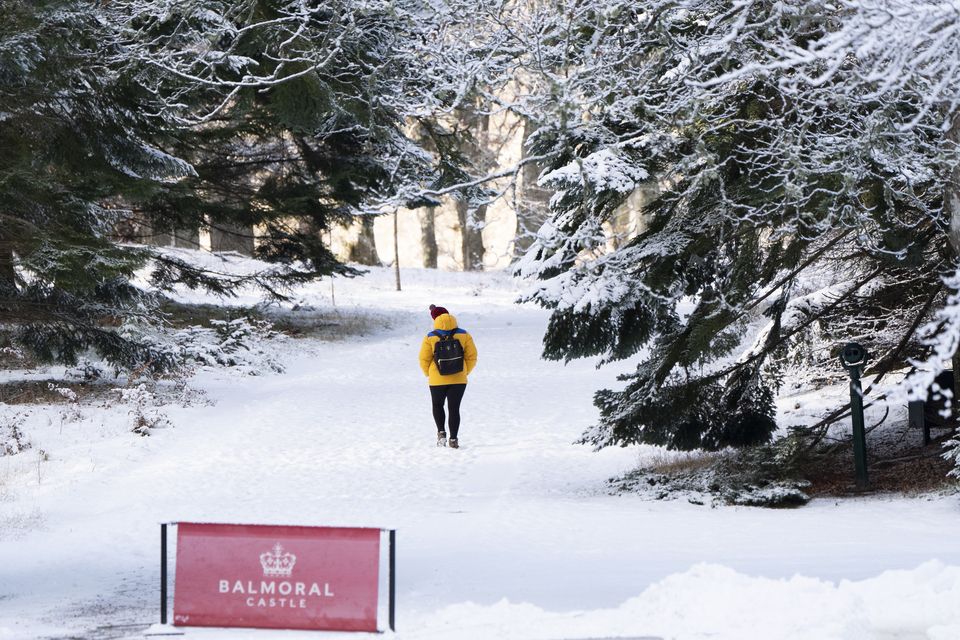 A person walks through the snow on the Balmoral Estate (Jane Barlow/PA)