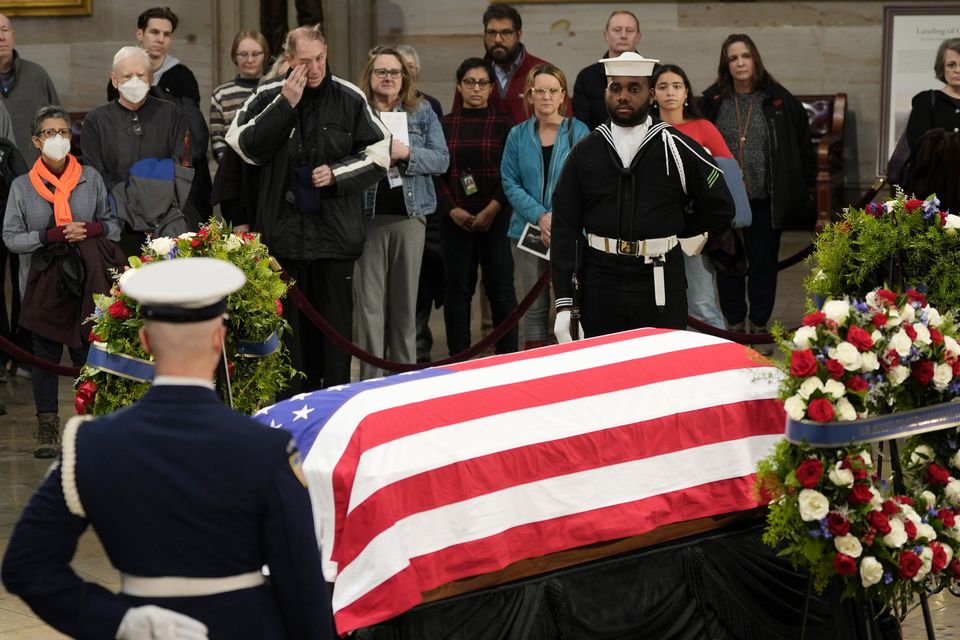 Guests pay their respects as the flag-draped casket of former President Jimmy Carter (Steve Helber/AP)