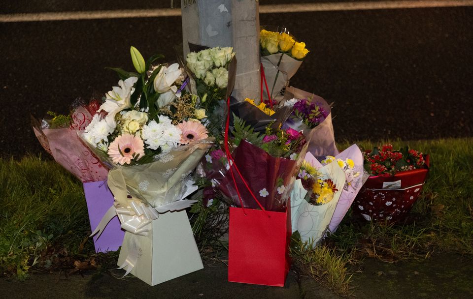 Floral tributes at the scene in Blanchardstown Road North (Evan Treacy/PA)