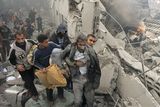 thumbnail: An injured Palestinian prisoner is helped as he and others flee through the rubble of the central security headquarters and prison, known as the Saraya, after it was hit in an Israeli missile strike in in Gaza City, Sunday, Dec. 28, 2008. More than 270 Palestinians have been killed and more than 600 people wounded since Israel's campaign to quash rocket barrages from Gaza began midday Saturday.(AP Photo/Adel Hana)