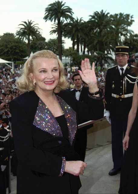 Gena Rowlands waves to the crowd as she arrives at the Festival Palace in Cannes Tuesday, May 23, 1995 (Laurent Rebours/AP)