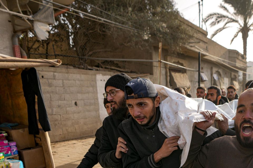 Mourners carry the bodies of five Palestinian journalists (Abdel Kareem Hana/AP)