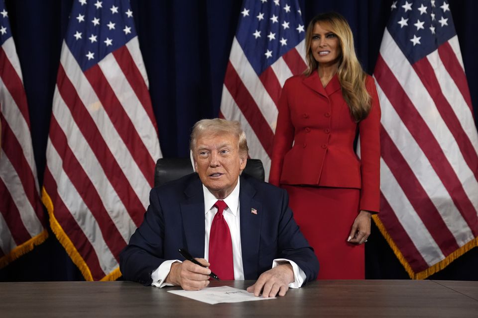 As Melania Trump watches, Republican presidential candidate former President Donald Trump signs paperwork to officially accept the nomination (Evan Vucci/AP)