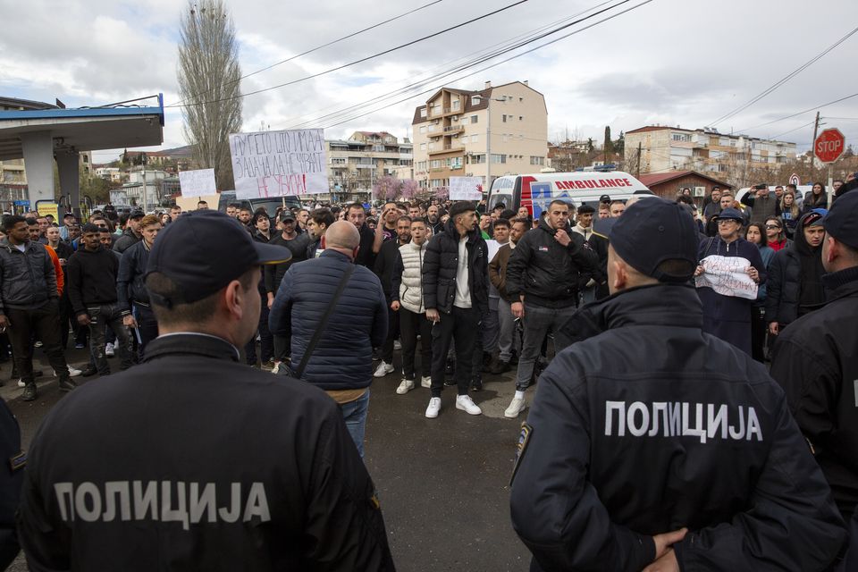 People confront police near the home of the owner of a nightclub that was the scene of a massive fire in the town of Kocani, North Macedonia (Visar Kryeziu/AP)